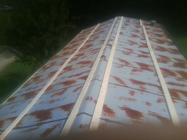 Rusted metal roof panels with new wood purlins before replacement — Storm Damage Roof Repair in Edmeston by Roofing Brothers