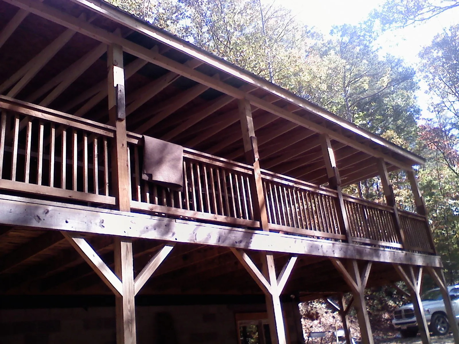 Timber framing under a new elevated porch and deck in Edmeston